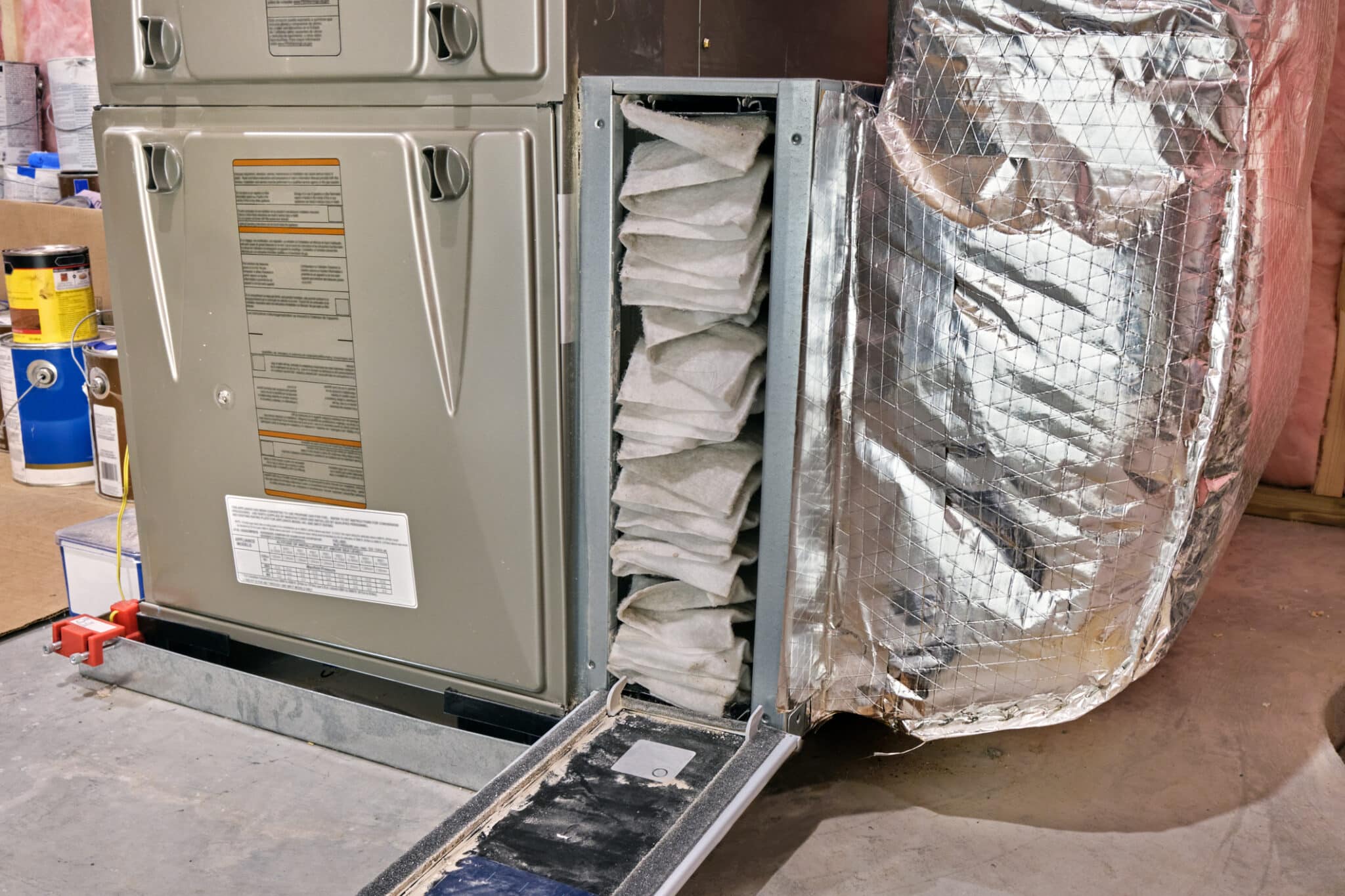 Furnace air filter opened for HVAC System inspection and cleaning or replacement.