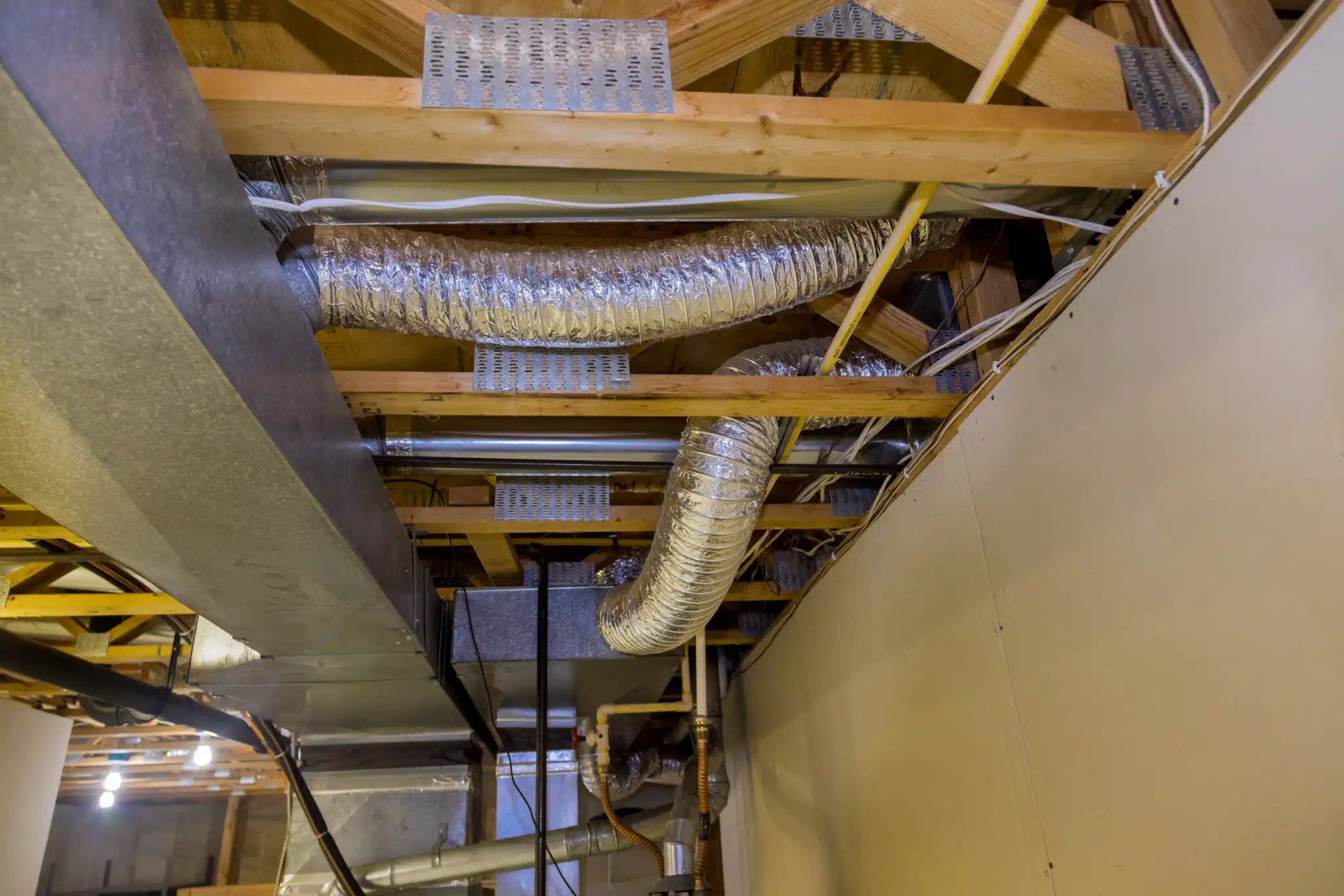 Framed home installation of air conditioner and heating ductwork in ceiling, Air Duct Sealing.