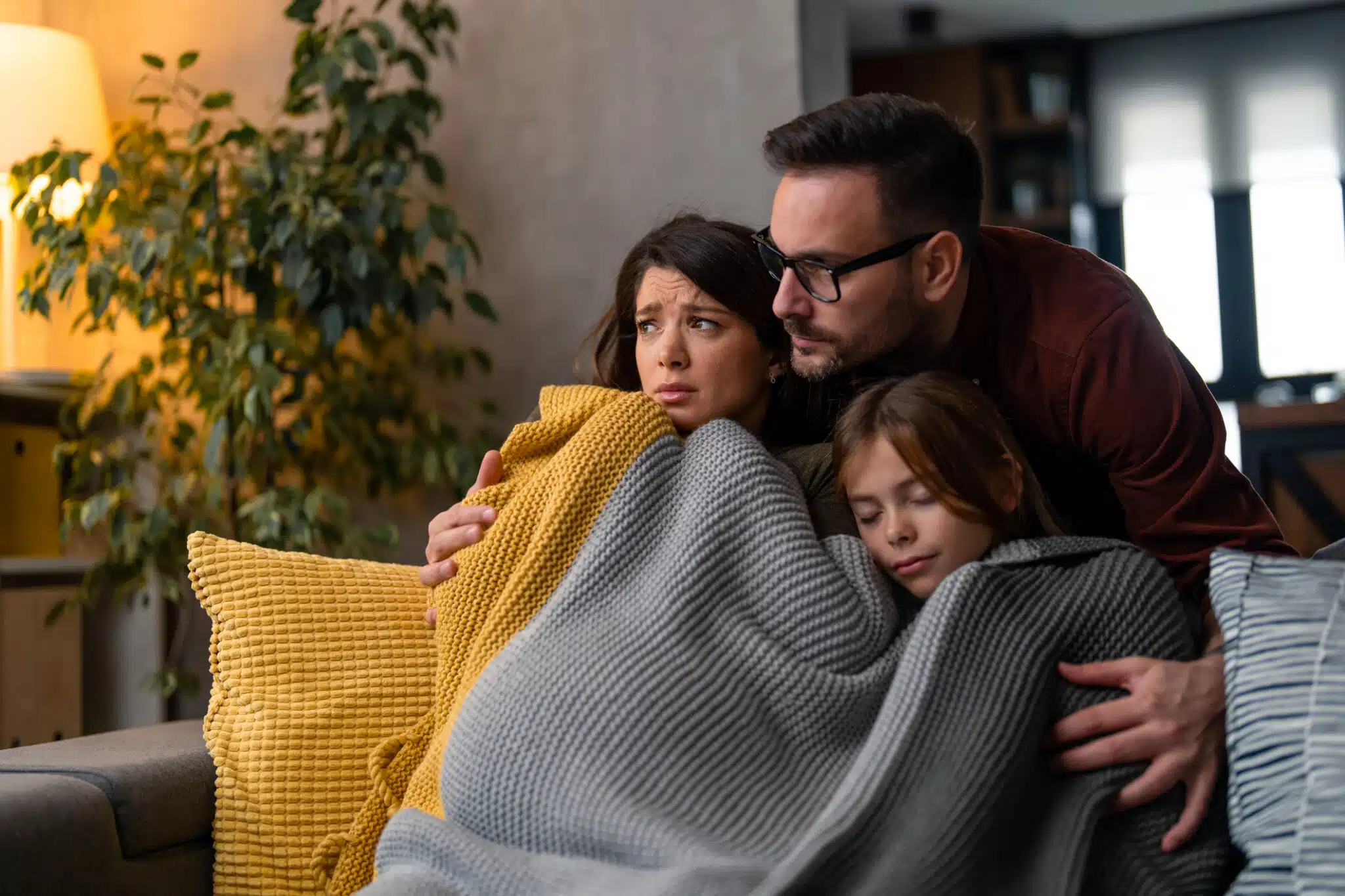 Causes of Heating System Failures. Mother, father and a daughter freezing at home.