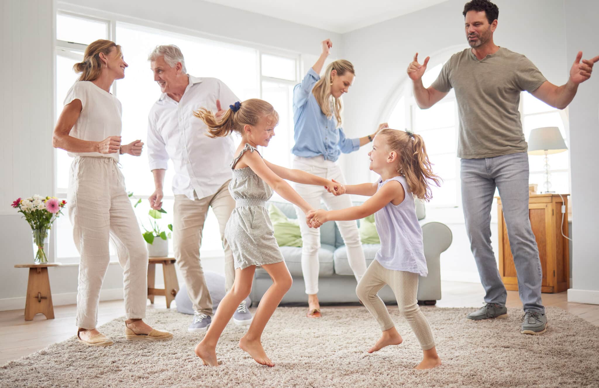Lifestyle, freedom and celebration dancing at modern home with parents, children and grandparents with Indoor Air Quality.