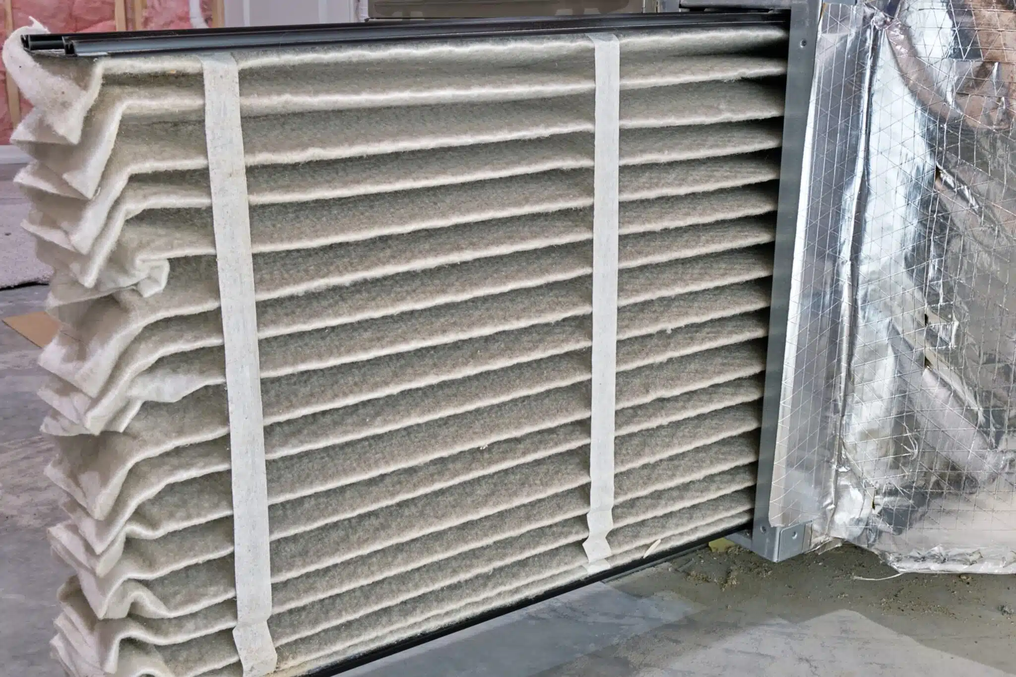 High efficiency furnace air filter pulled out for inspection and cleaning, Furnace.