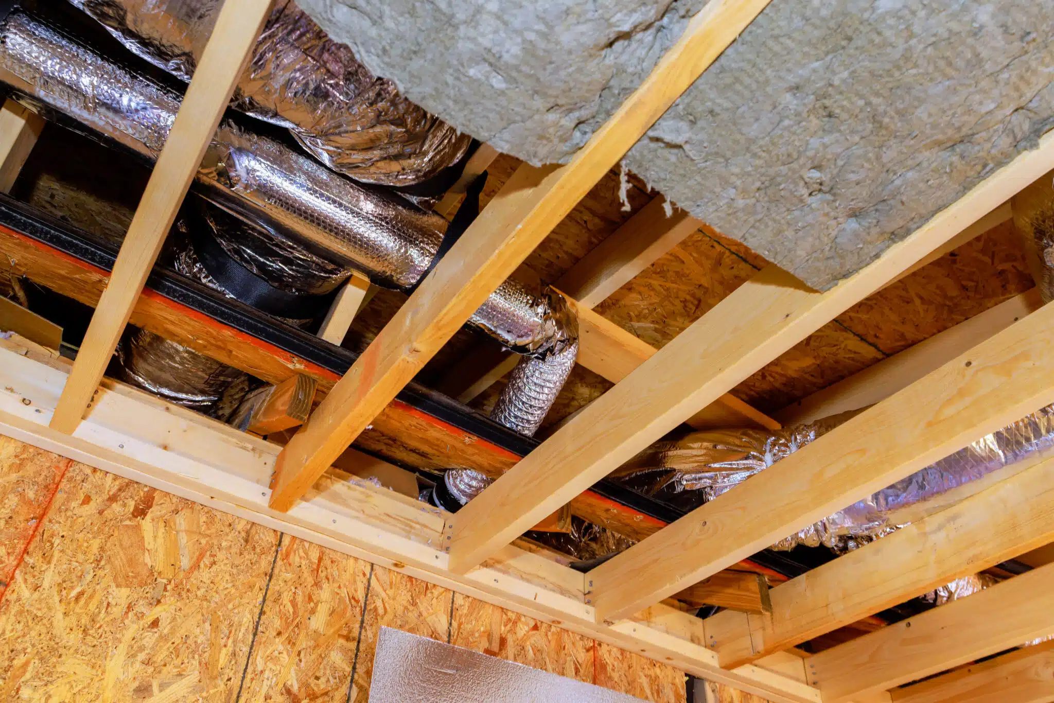 Installing insulation, ductwork with in ceiling framework of at new home, Heat Pump.