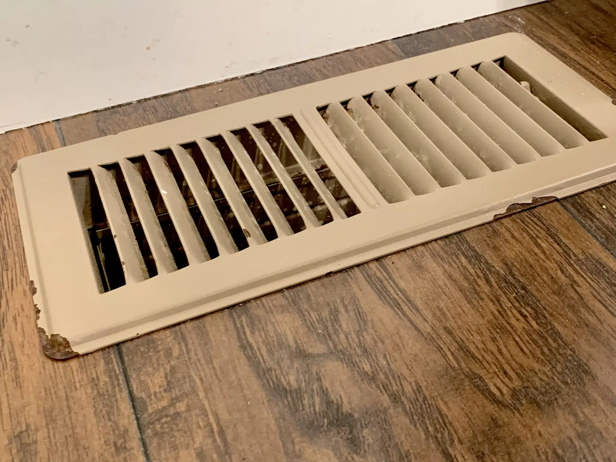 Rusted old tan floor air vent, AC Repair.