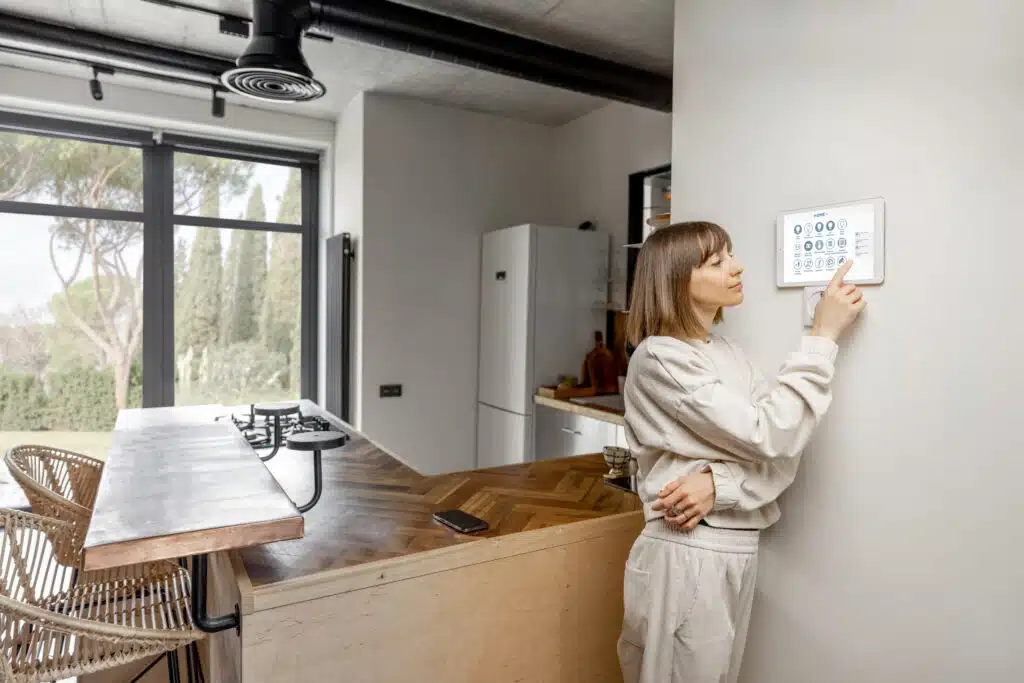 Woman controlling home devices, Smart HVAC